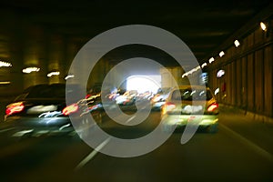 Cars moving traffic with brurred headlights