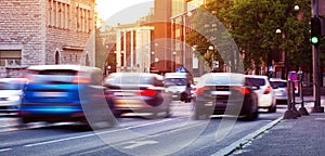 Cars moving on the urban road at dusk