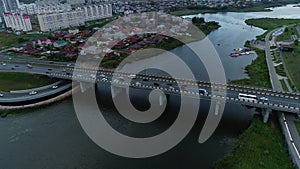 Cars navigate lanes of city bridge during rush hour