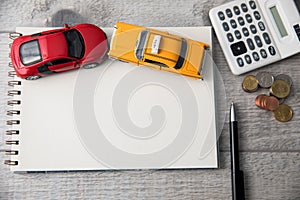 Cars on notepad with calculator