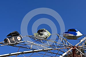 Cars on an old carnival ride using centrifugal force for thrills