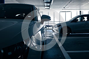 Cars parked in a garage with no people.