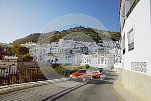 Cars parked on the roadside in the white village