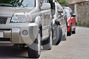 Cars parked in a row on a city street