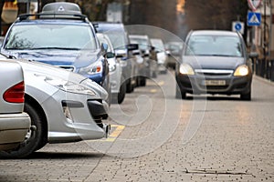 Cars parked in a row on a city street side