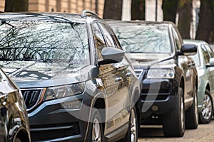 Cars parked in a row on a city street side