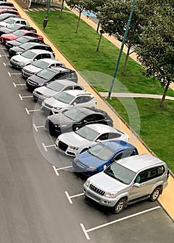 Cars parked in a row in a street parking