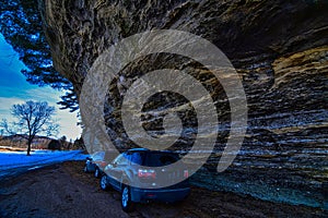 Cars parked under the overhanging cliffs at pier County park