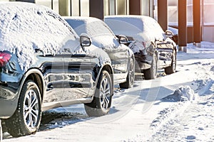 Cars in the parking lot covered with snow
