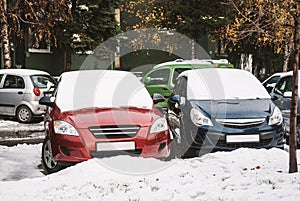 Cars in the parking lot, covered with snow