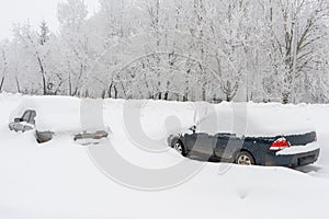 Cars in the parking lot covered with snow after a snowstorm