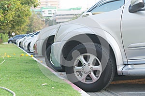 Cars parking in a tidy row in open area