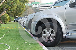 Cars parking in a tidy row in open area