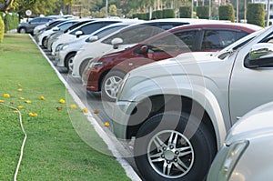 Cars parking in a tidy row in open area