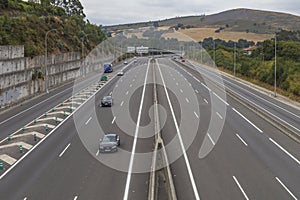 Cars passing on a modern a highway in the outskirts of Santiago de Compostela, Galicia, Spain.