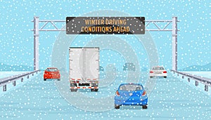 Cars passing through warning led display at highway. Winter driving conditions.