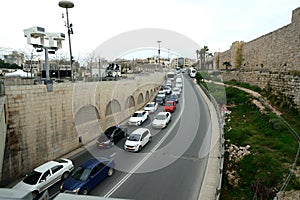 Cars on road between ancient & modern Jerusalem