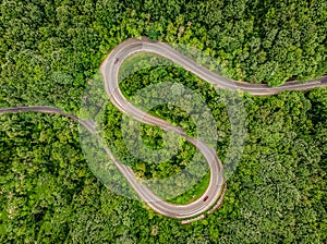 Cars on road. Extrem winding road in the middle of the forest, C