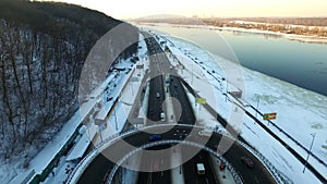 Cars on road junction in winter city. Aerial view car traffic on winter highway