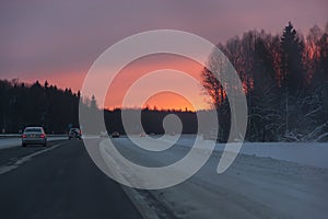 Cars in the road, winter at sunset