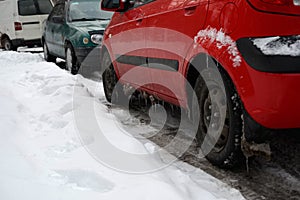 Cars on snow-cowered street