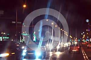 Cars and street lights in night city on the road. Abstract blur urban city street road and lighting bokeh for background