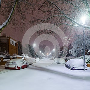 Cars and streets covered in snow in night image of Filomena storm fall in Madrid Spain. Winter photo