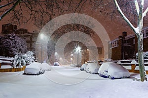 Cars and streets covered in snow in night image of Filomena storm fall in Madrid Spain. Winter photo