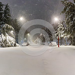 Cars and streets covered in snow in night image of Filomena storm fall in Madrid Spain. Europe photo