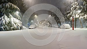 Cars and streets covered in snow in night image of Filomena storm fall in Madrid Spain. Europe photo
