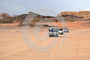 Cars of tourists in search of adventures in the desert