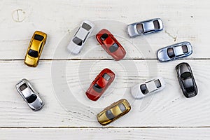 Cars toys on white wooden background. Top view