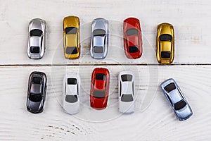 Cars toys on white wooden background. Top view