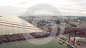 Cars, trains, bus on 25 April bridge in Lisbon aerial view