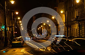 Cars, trams, streetlights and people. Night life of the city.