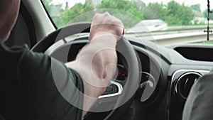 Cars, transport, travel, professional concept - close-up of side naked hands of driver on short sleeve hold steering