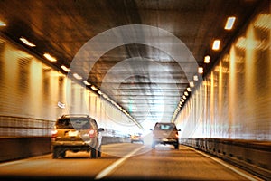 Cars traveling through a tunnel.