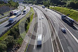 cars and trucks driving fast on the road transporting people and delivering supplies