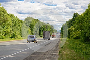 Cars and trucks ride along the highway