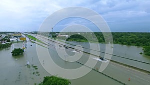 Cars and trucks trying to drive through flooded i45 near Houston Texas