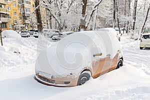 Cars under snow on parking. Heavy snowfall aftermath. City infrastructure and disaster recovery. Vehicles after snow. Climate