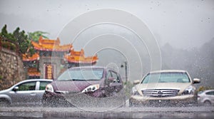 Cars under torrential rain on city street