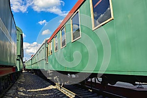Between cars of vintage trains, between two old trains, old green wagons photo