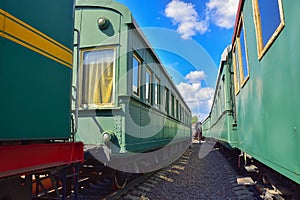 Between cars of vintage trains, between two old trains, old green wagons photo