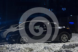 Cars on a winter night in a parking lot