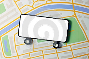 Carsharing, car rental and taxi service mobile app - phone with wheels and blank screen on city map photo