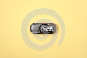 Carsharing concept. Toy car and text sign