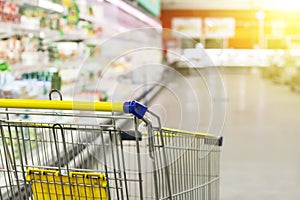Cart at the grocery store. Abstract blurred photo of store with trolley in department store bokeh background.