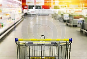 Cart at the grocery store. Abstract blurred photo of store with trolley in department store bokeh background.