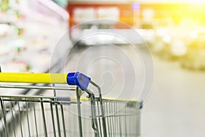 Cart at the grocery store. Abstract blurred photo of store with trolley in department store bokeh background.